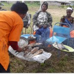 women roasting fish during the ACWW wORLD pRESIDENT VISIT WOmen roaating fish